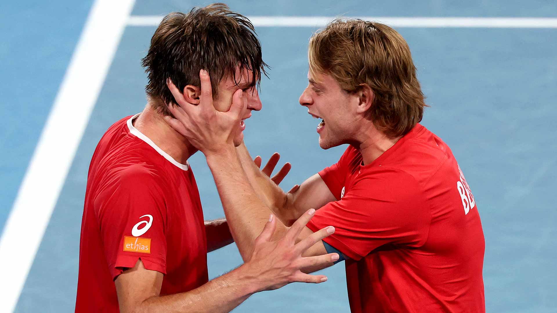 Raphael Collignon is embraced by Zizou Bergs after clinching victory for Belgium on Sunday in Sydney.