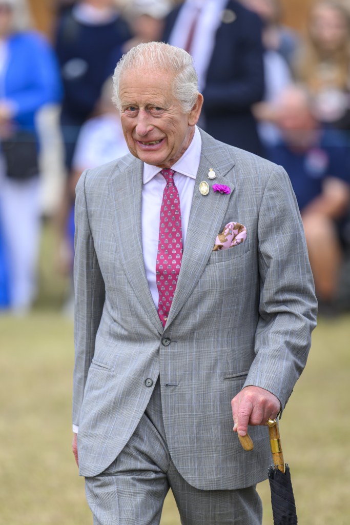 King Charles walking in grey suit at Sandringham Flower Show 