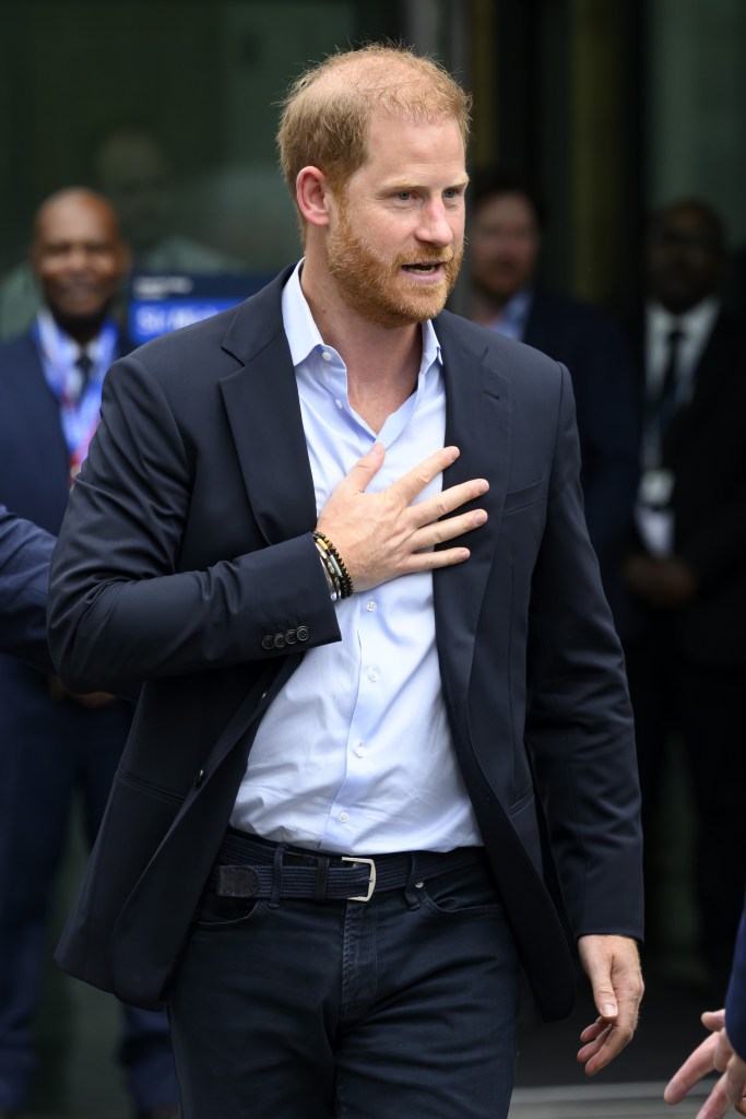 Prince Harry with hand on his chest 