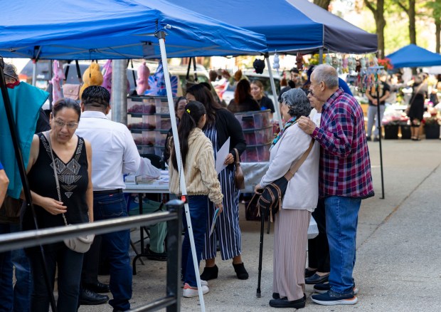 People shop along the street, Aug. 31, 2025, in Chicago's Little Village neighborhood. (Brian Cassella/Chicago Tribune)