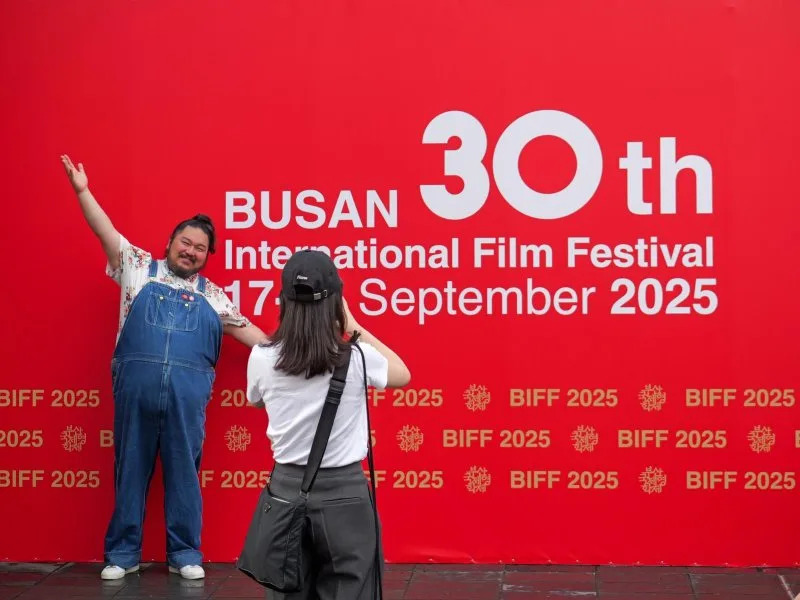 Movie fans pose at a photo wall after buying tickets at the Busan International Film Festival on Wednesday. Photo by Thomas Maresca/UPI