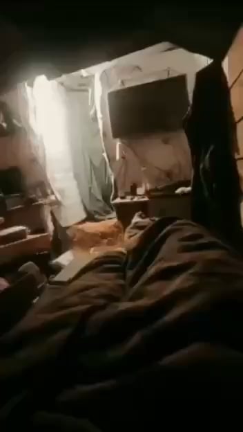 A Russian soldier is filming the impact of a Ukrainian FPV quad on his position while resting in his bunk bed.  Zaporizhzhia Oblast.