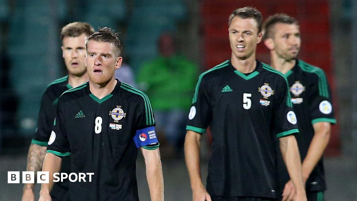 Steven Davis and Jonny Evans look dejected after Northern Ireland's 2013 defeat by Luxembourg