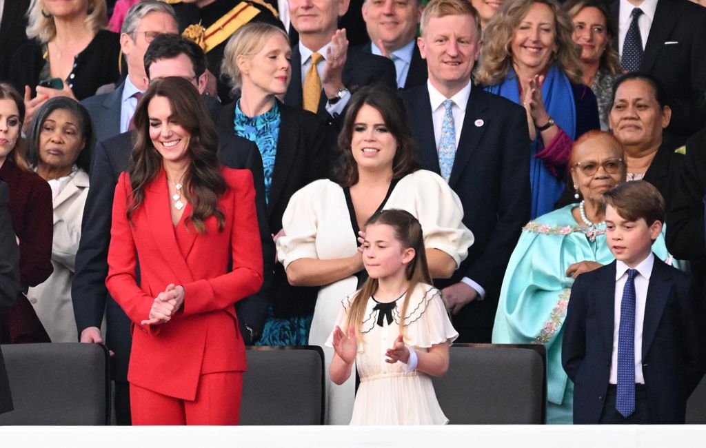 Princess Kate in red suit with long brunette hair