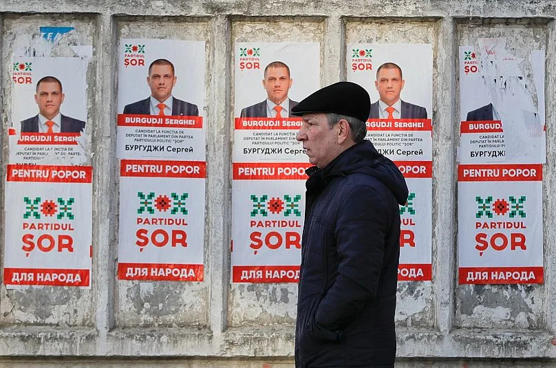 A man walks by electoral posters advertising the candidates of the Shor party led by Moldovan businessman Ilan Shor in Chișinău, 21 February, 2019