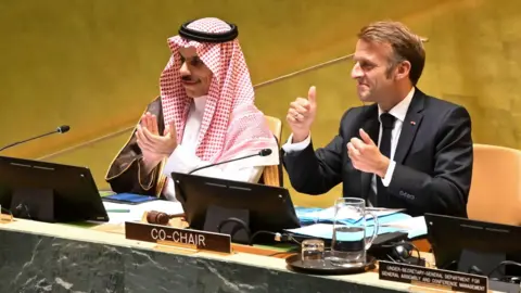 EPA Saudi Foreign Minister Prince Faisal bin Farhan (L) and French President Emmanuel Macron (R) gesture during the High-level International Conference for Peaceful Settlement of the Question of Palestine and Implementation of the Two-State Solution at the UN headquarters in New York (22 September 2025)