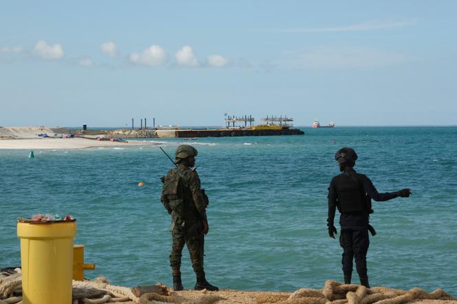A Rwandan police officer (right) and a Rwandan soldier guard the Total Mozambique LNG project in Afungi, Cabo Delgado province, Mozambique, on September 29, 2022.