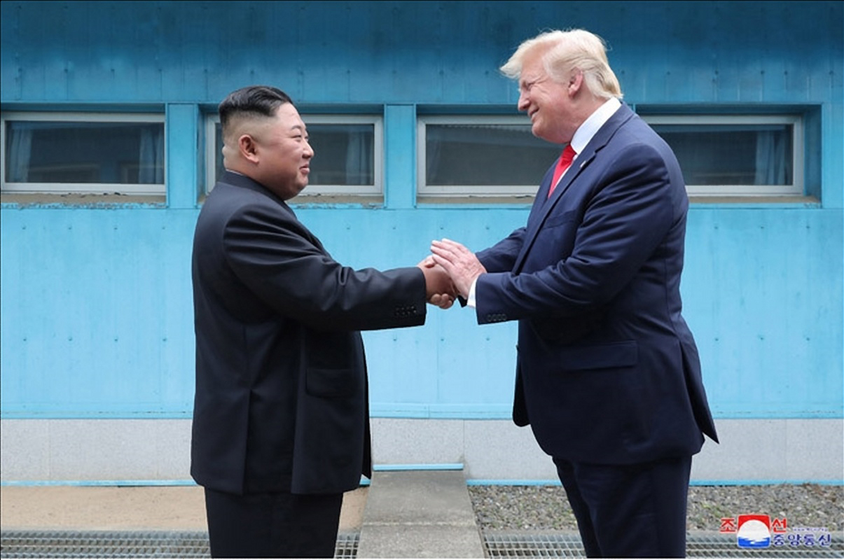 Kim Jong-un, chairman of North Korea’s State Affairs Commission (left), and U.S. President Donald Trump met at Panmunjom on June 30, 2019, North Korea’s state-run Korean Central News Agency reported on July 1. The photo, released on the agency’s website, shows the two leaders shaking hands across the Military Demarcation Line. [KCNA WEBSITE/YONHAP]