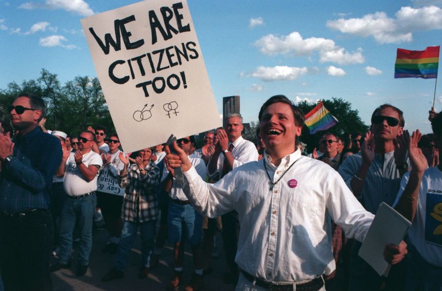 A man cheers during a rally in St. Paul, Minnesota, celebrating the US Supreme Court striking down an anti-gay law from Colorado, in May 1996.