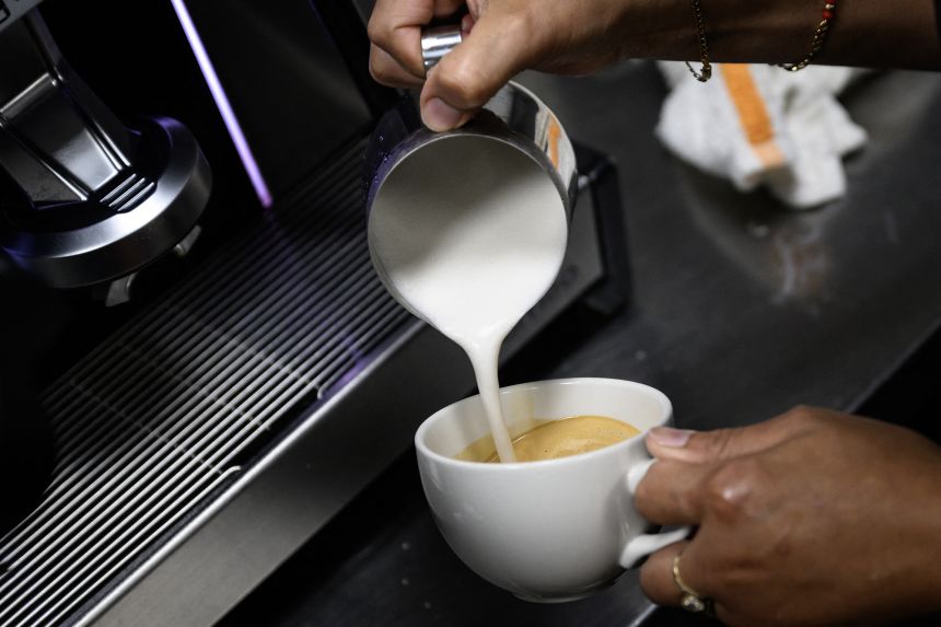 A barista makes a latte in Washington, DC, on July 2. Compared to a year ago, coffee prices are up 20.9%, a near-record annual increase.