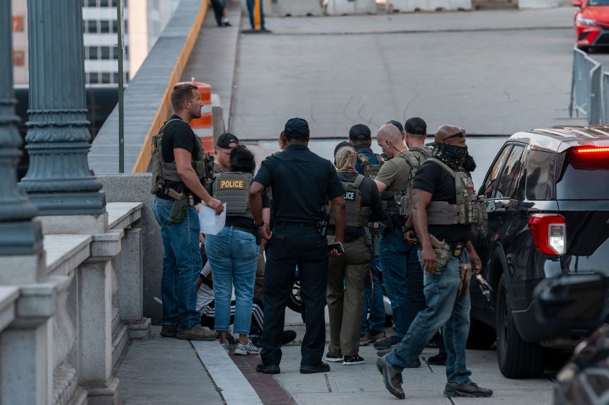 Federal agents, including ICE officers, take a delivery driver into custody at Union Station in Washington, DC, on August 16.