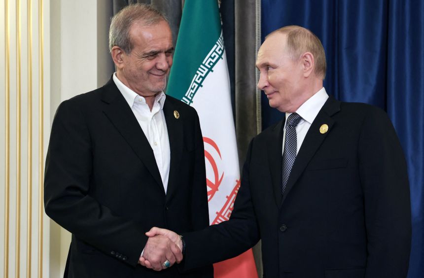 Russia's President Vladimir Putin shakes hands with Iran's President Masoud Pezeshkian during a meeting in Tianjin, China, on Monday.