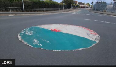 A Welsh flag and "obscene" anti-English graffiti have been painted on a roundabout in a north Wales seaside town.
