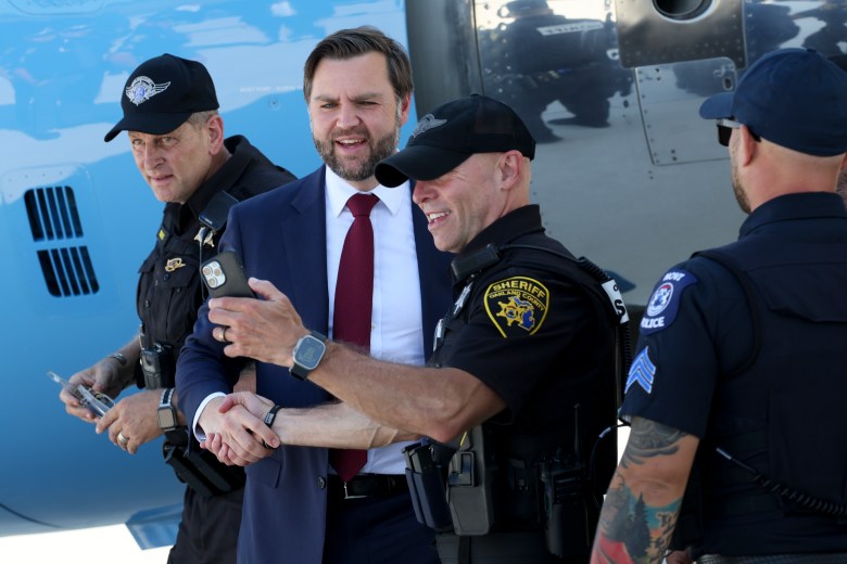 Vice President JD Vance takes a photo with an Oakland County Sheriff's deputy.