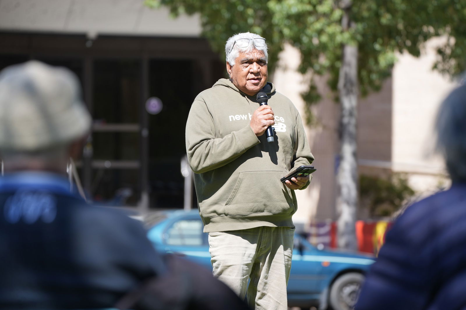 Faron peckham speaks into a microphone 