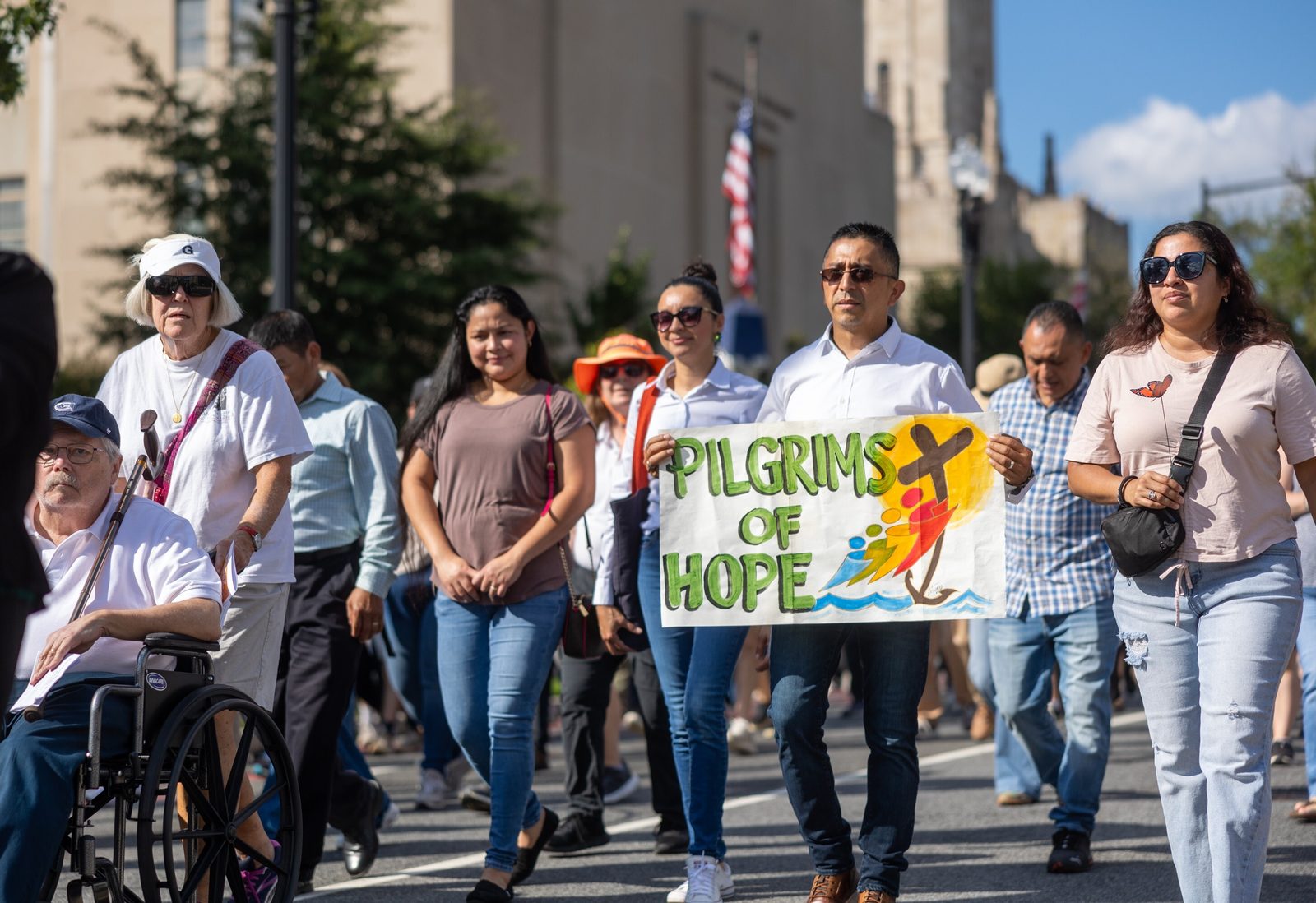 People walk in a procession for the 111th World Day of Migrants and Refugees on Sept. 28, 2025 that began at the Shrine of the Sacred Heart in Washington, D.C., wound down 16th Street, and concluded at the Cathedral of St. Matthew the Apostle. (Catholic Standard photo by Mihoko Owada)