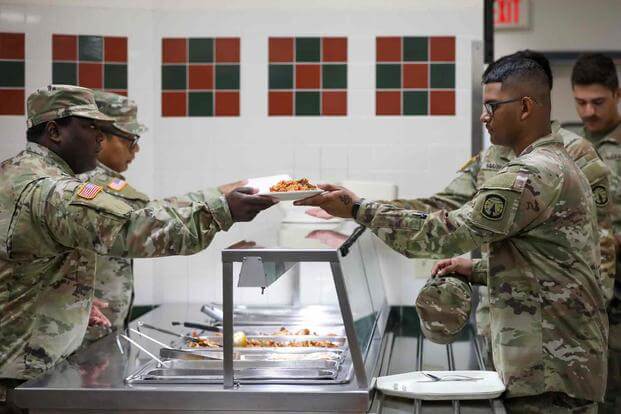 Soldier serves lunch to at the Muleskinner Warrior Restaurant, Fort Drum,
