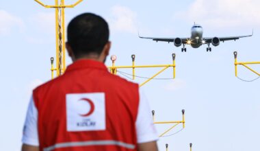 A Turkish Red Crescent worker is seen with a plane that looks to be landing at an unspecified location. (Photo via Turkish Red Crescent)