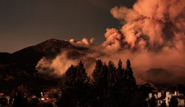 A large plume of smoke billowing out of the sky
