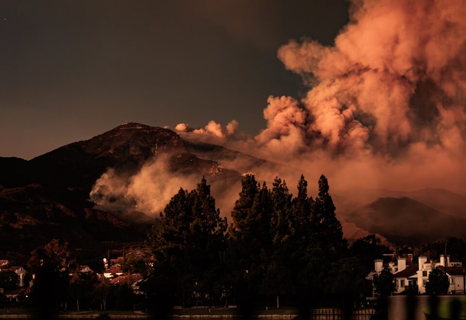 A large plume of smoke billowing out of the sky