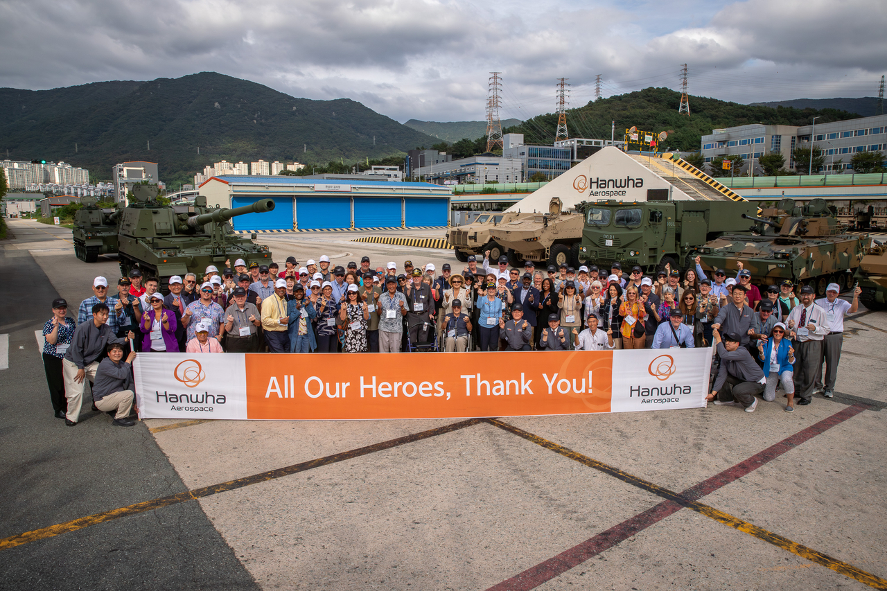 A group of 85 Korean War veterans, US military personnel stationed in Korea and their families pose with Hanwha Group officials at Hanwha Aerospace’s Changwon factory in South Gyeongsang Province, during an event celebrating 72 years of the South Korea-US alliance on Friday. (Hanwha Aerospace)