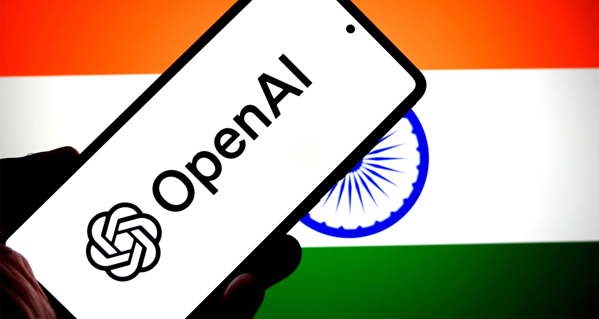 OpenAI logo on a phone in front of an Indian flag.
