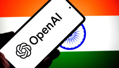 OpenAI logo on a phone in front of an Indian flag.