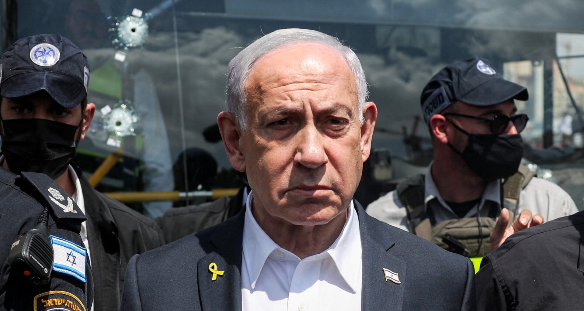 Benjamin Netanyahu standing in front of soldiers
