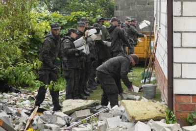 Officers clean up debris from Russian drones