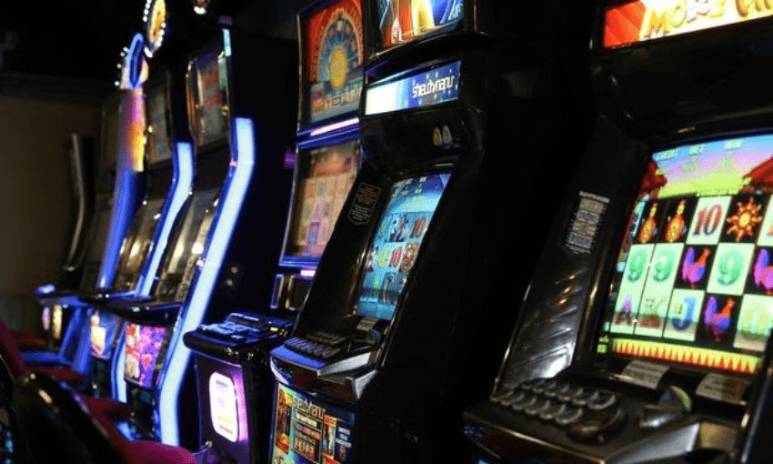Brightly-coloured pokie machines lined up in a bar.