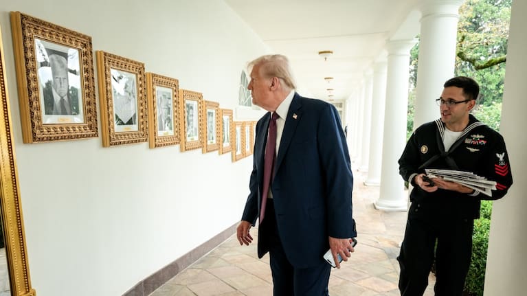 President Donald Trump looks at the Presidential Walk of Fame