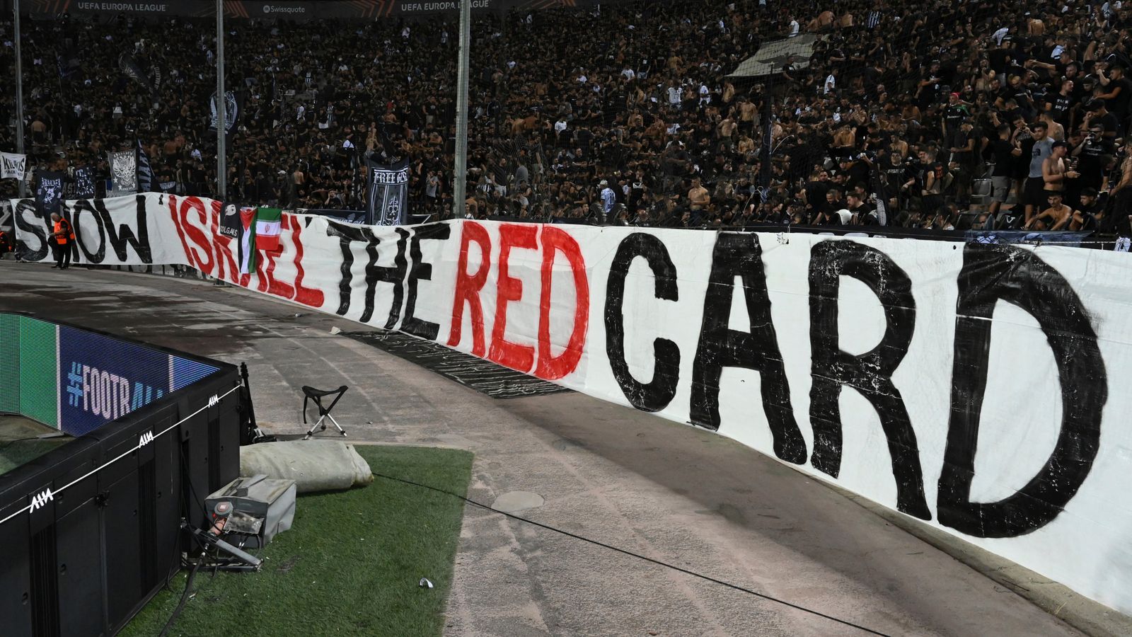 PAOK fans display a huge banner that read 'Show Israel the red card' during a match between PAOK and Maccabi Tel Aviv. Pic: AP