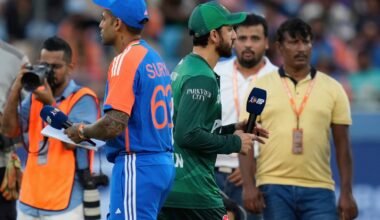Pakistan's captain Salman Agha, right, walks past India's captain Suryakumar Yadav after the coin toss ahead of the Asia Cup cricket match between India and Pakistan at Dubai International Cricket Stadium in Dubai, United Arab Emirates, Sunday, Sept. 14, 2025. (AP Photo)