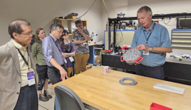 person demonstrating a space science instrument
