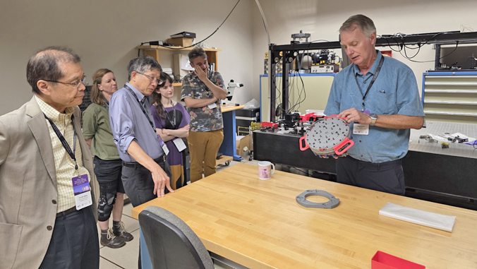 person demonstrating a space science instrument
