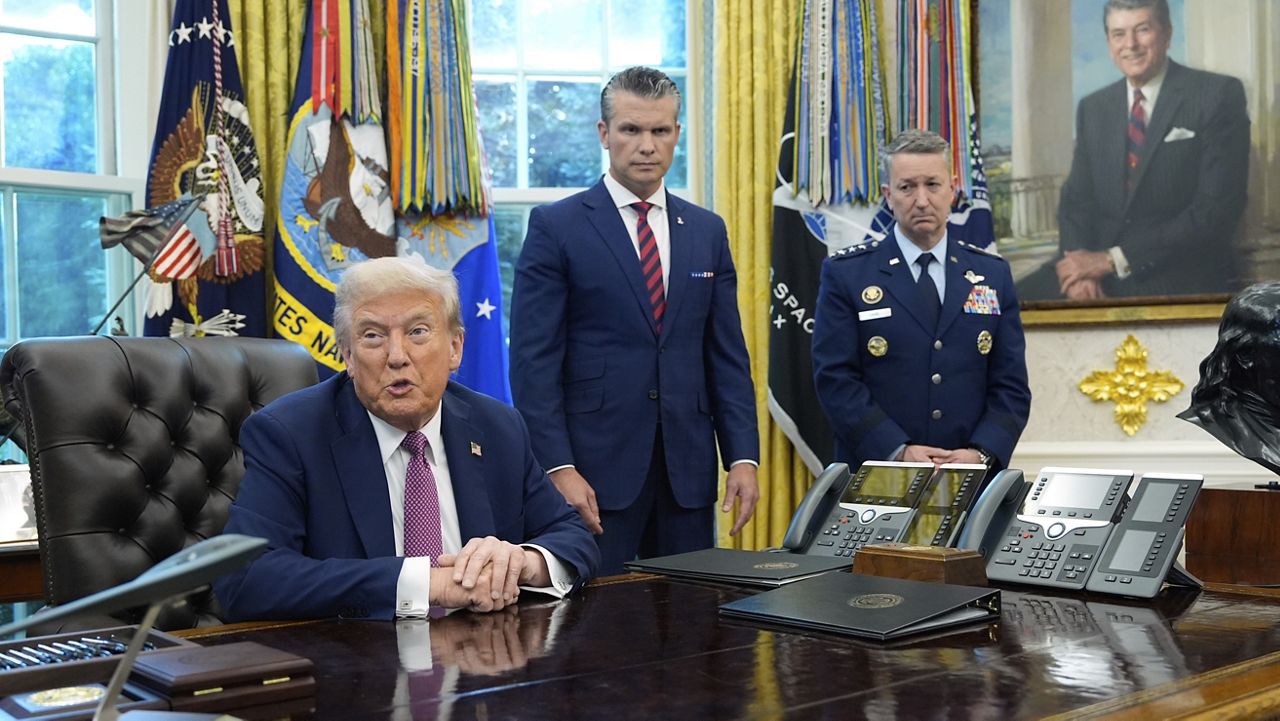President Donald Trump speaks in the Oval Office of the White House, Friday, Sept. 5, 2025, in Washington, as Defense Secretary Pete Hegseth and Chairman of the Joint Chiefs of Staff Gen. Dan Caine listen. (AP Photo/Alex Brandon)