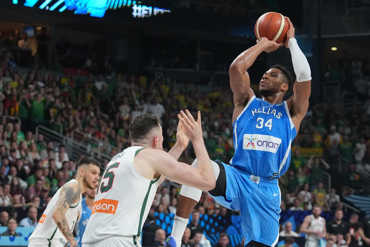 Greece's small forward #34 Giannis Antetokounmpo (R) vies with Lithuania's center #15 Laurynas Birutis (C) during the FIBA EuroBasket 2025 basketball quarter final match between Lithuania and Greece at the Arena Riga in Riga, Latvia, September 9, 2025. (AFP Photo)