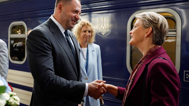 Head of the Office of the President of Ukraine Andriy Yermak, left, shakes hands with British Foreign Secretary Yvette Cooper