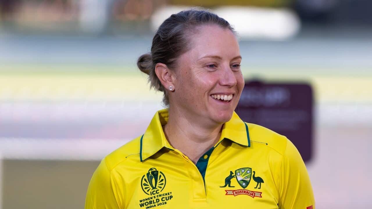 A woman in a yellow shirt that says Australia in green letters