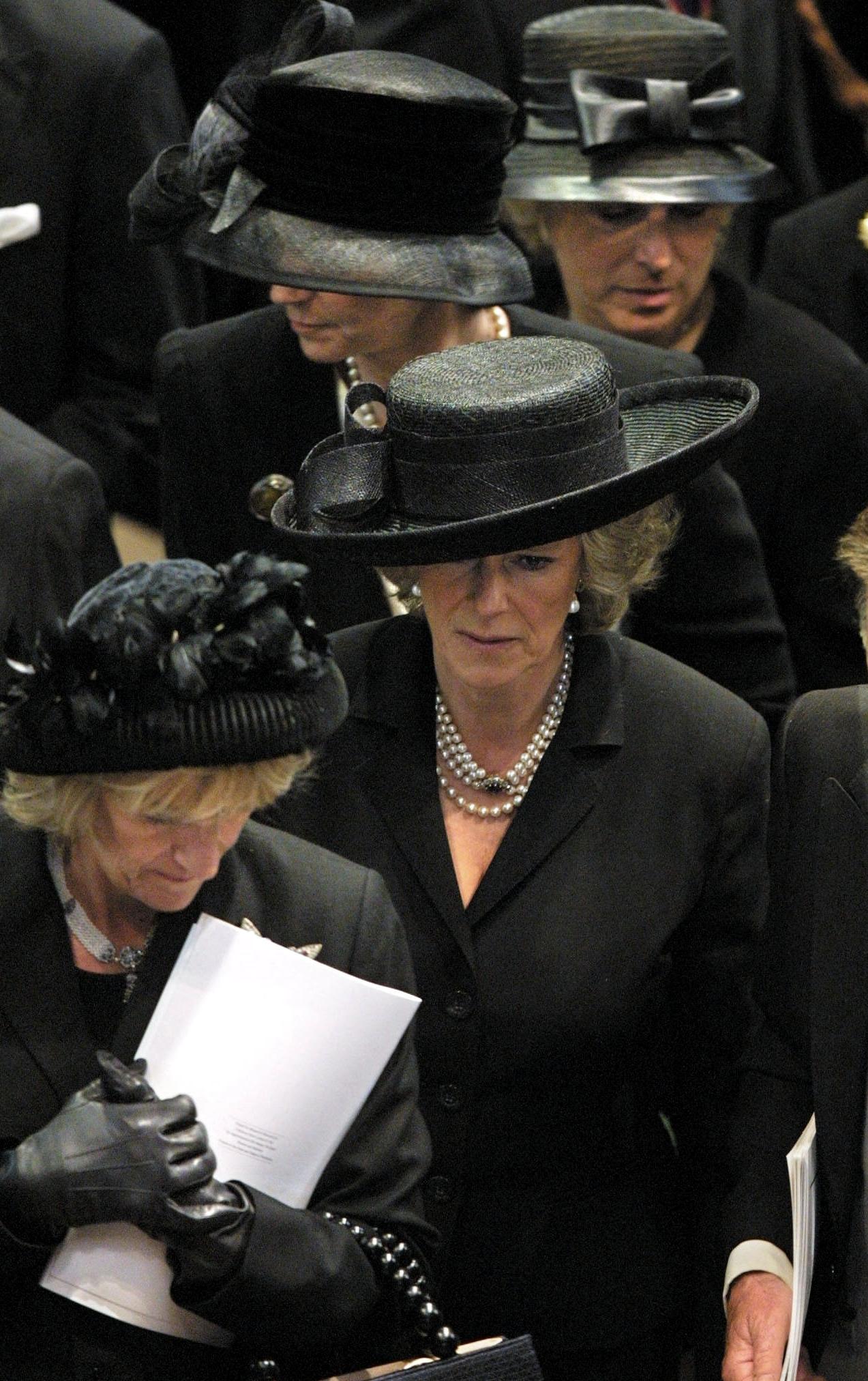Queen Camilla wears a black outfit to attend the Queen Mother's funeral on April 9, 2002