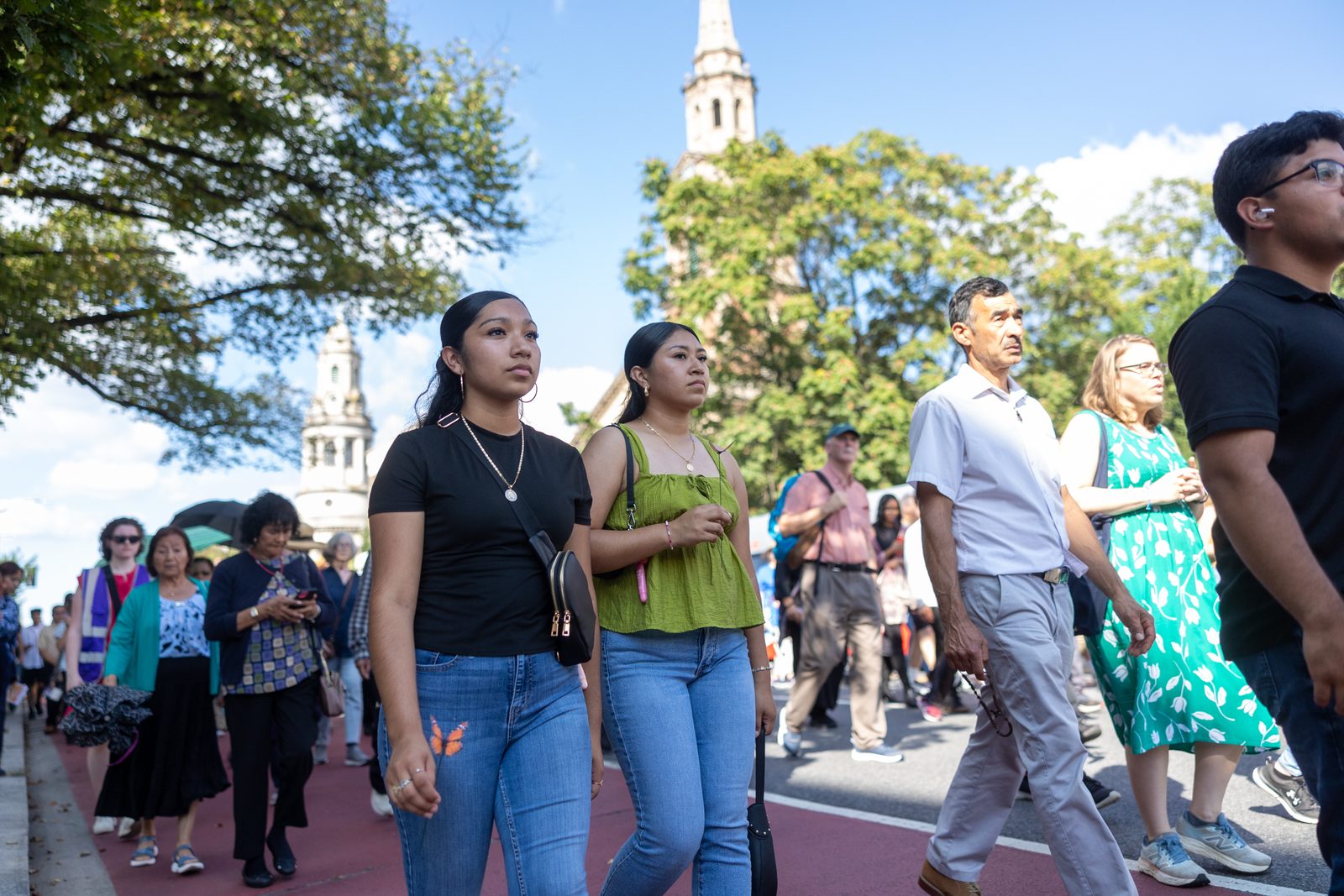 People walk in a procession for the 111th World Day of Migrants and Refugees on Sept. 28, 2025 that began at the Shrine of the Sacred Heart in Washington, D.C., wound down 16th Street, and concluded at the Cathedral of St. Matthew the Apostle. (Catholic Standard photos by Mihoko Owada)