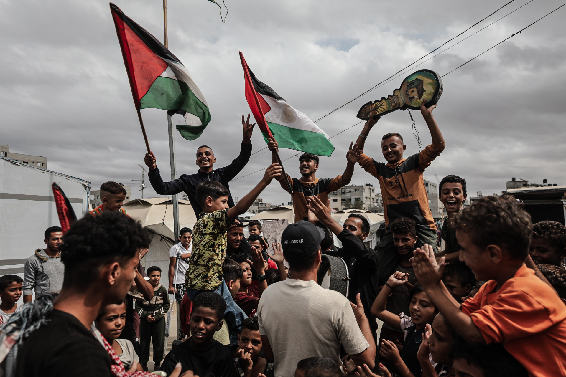 Palestinians gather at the Nuseirat refugee camp celebrate after the announcement of the ceasefire agreement in Gaza