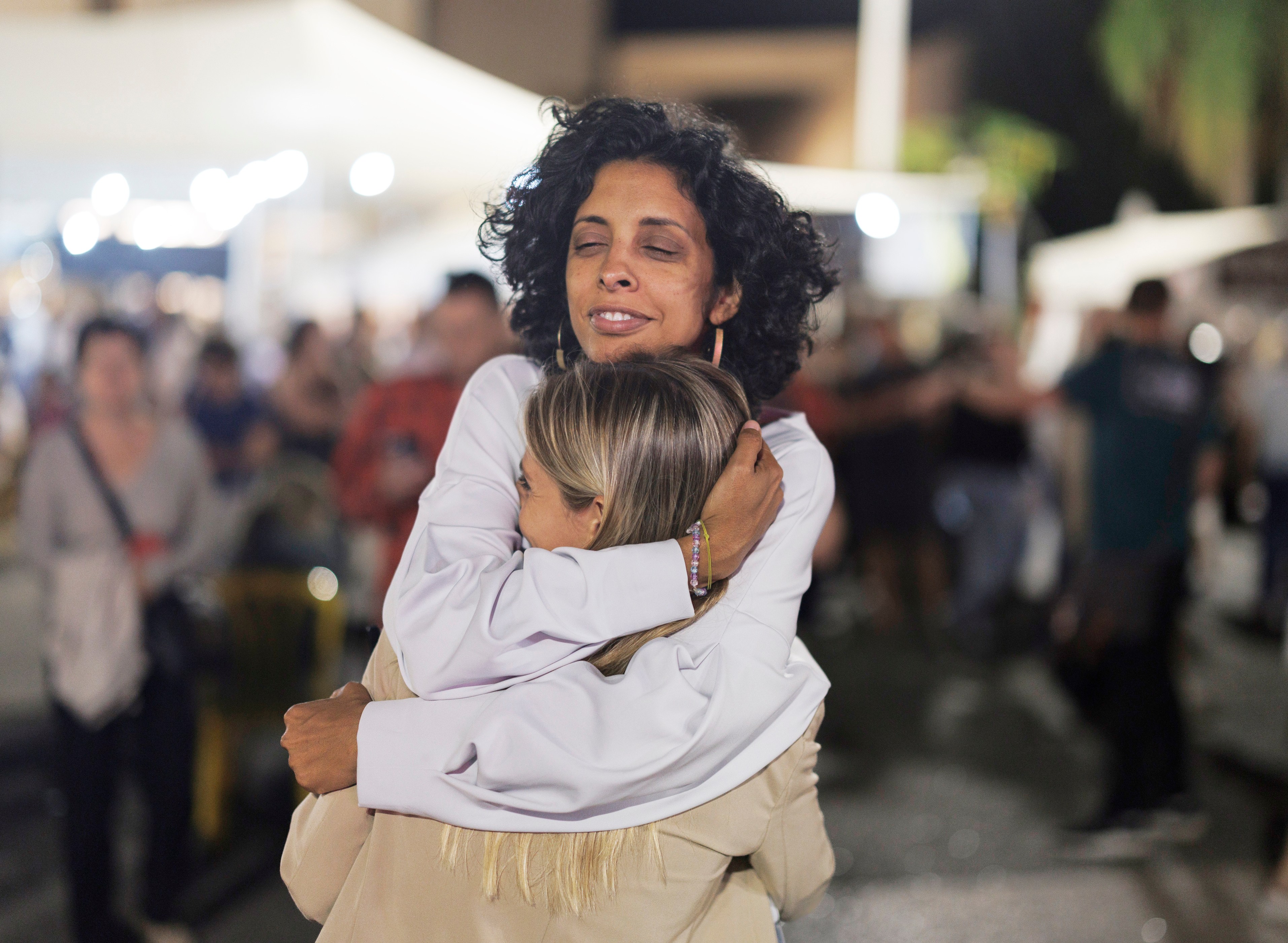Israelis celebrate by hugging in Tel Aviv after the announcement of a deal between Israel and Hamas for the release of hostages.