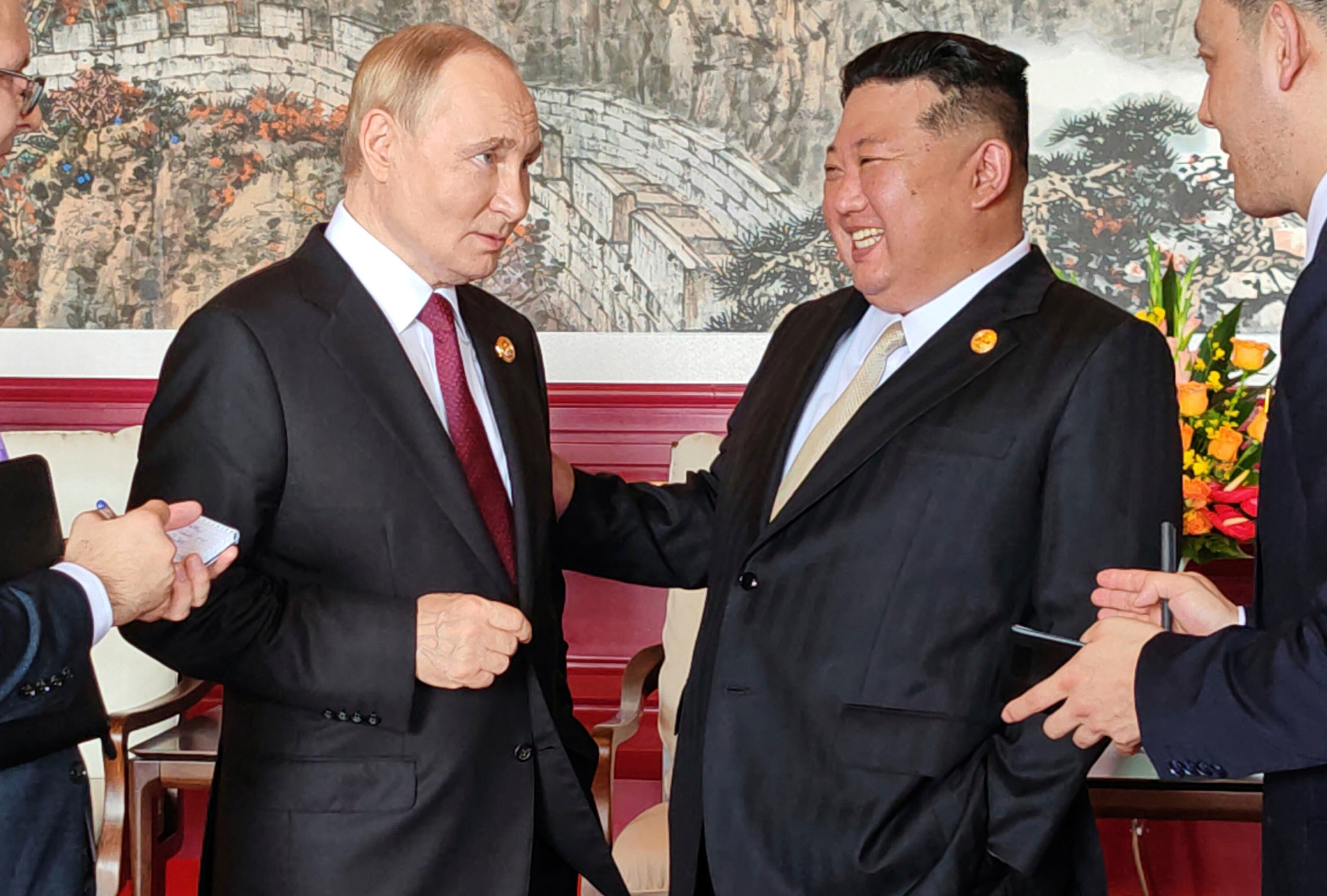 North Korean leader Kim Jong Un and Russian President Vladimir Putin talk in Beijing.