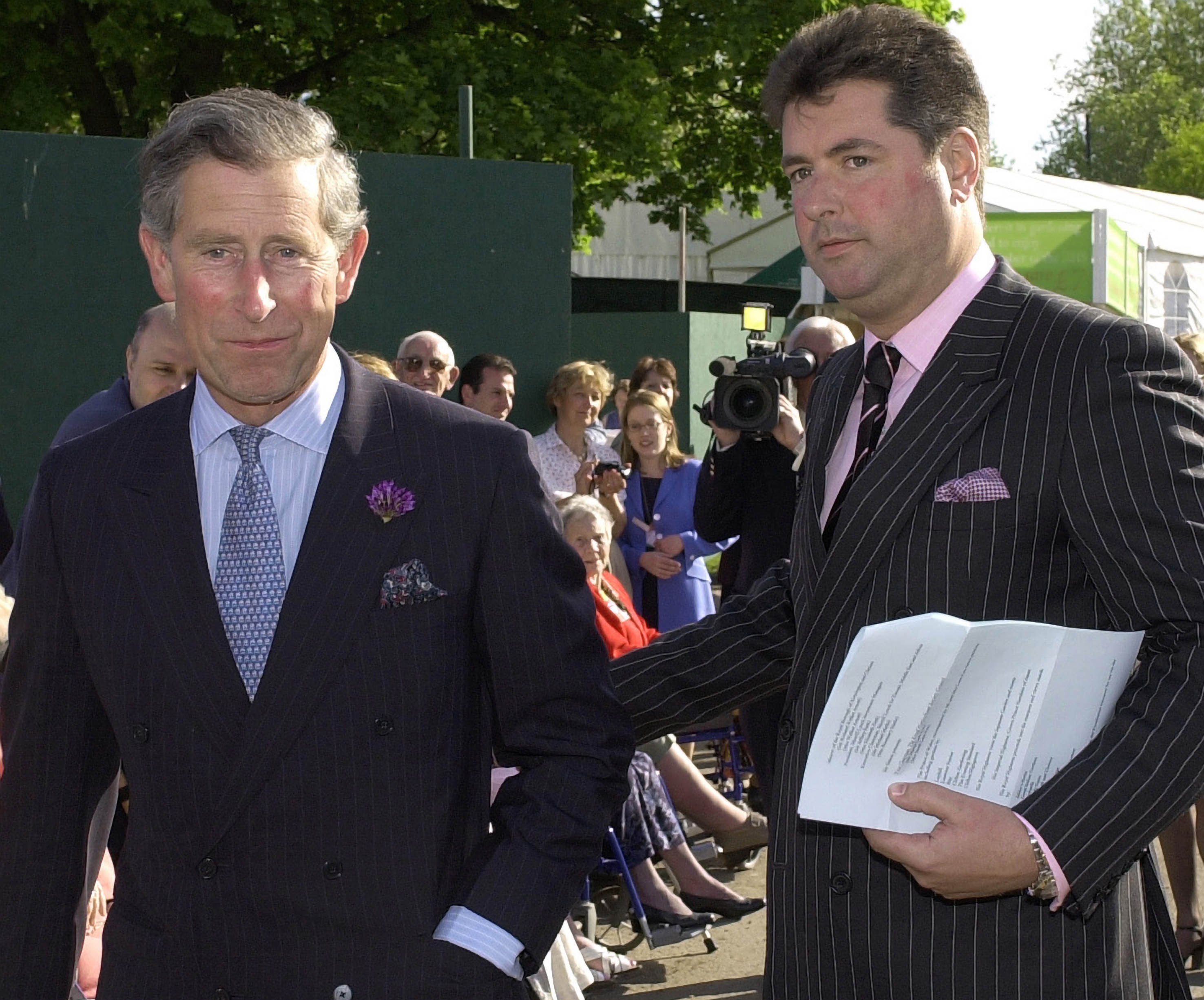 Prince Charles and Michael Fawcett, his valet, in pinstripe suits.