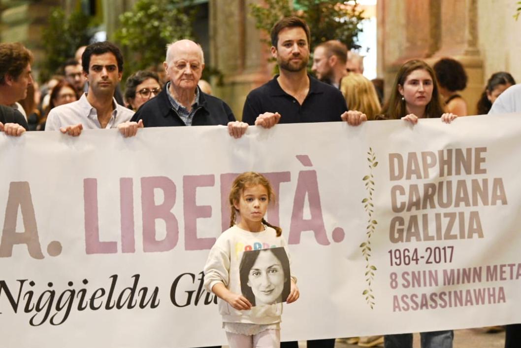 Caruana Galizia’s granddaughter carrying a photo of Daphne. Photo: Matthew Mirabelli