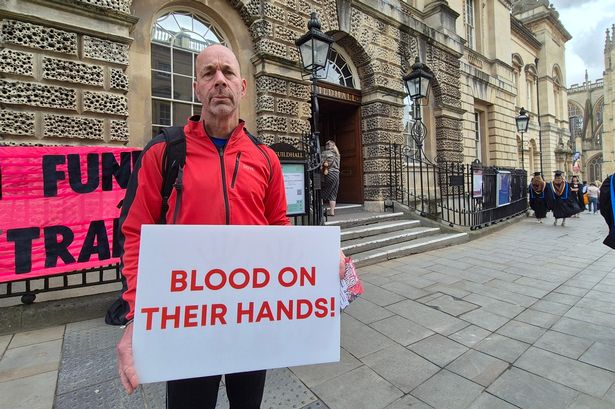 A pro-Palestine protester outside Bath Guildhall ahead of a meeting of the Avon Pension Fund committee