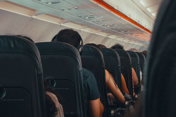 Seated passengers on board a plane, generic