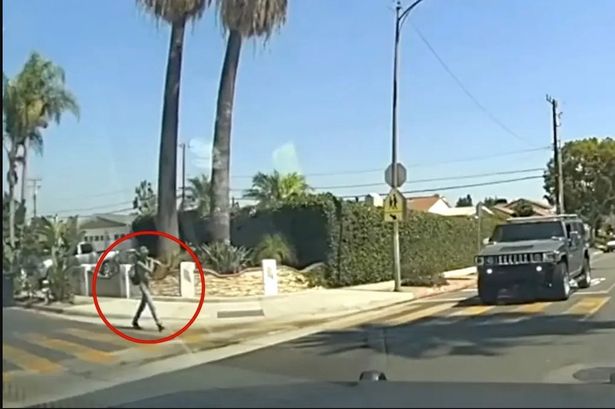 The officer barely steps out of his cruiser when the madman starts swinging the weapon. 

