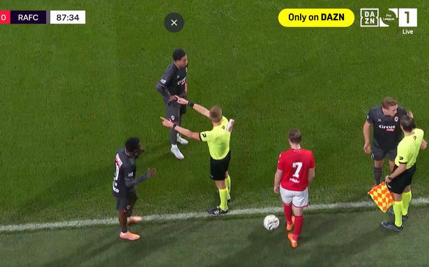 The referee is hit by a thrown cup during Standard Liege vs Royal Antwerp 